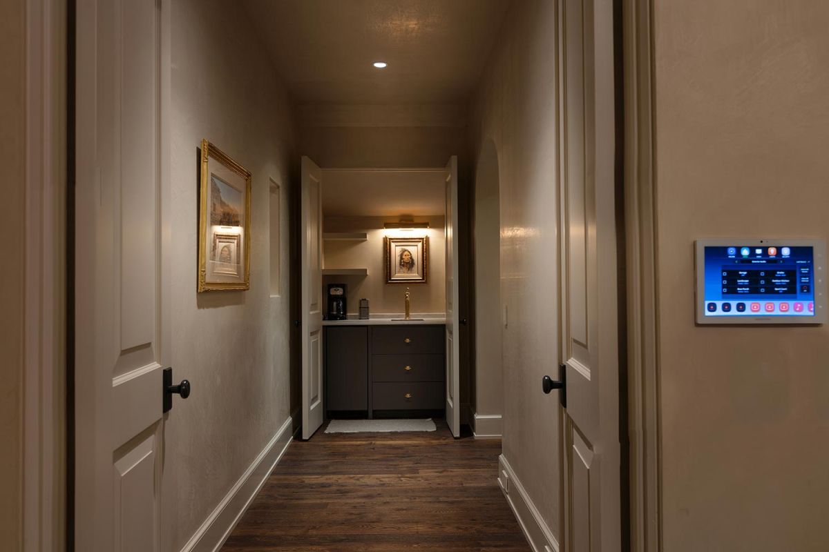 Narrow hallway with bar nook and classic framed artwork