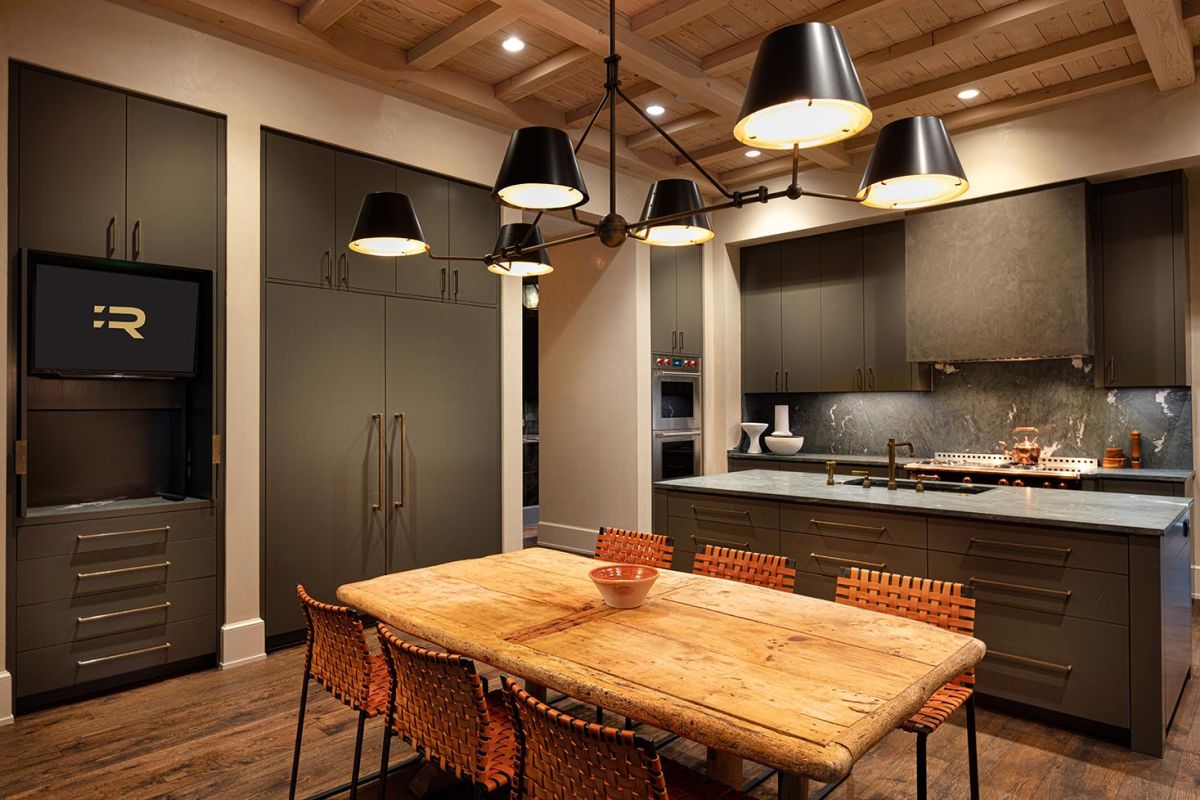 Intimate dining room with round wood table and crystal chandelier