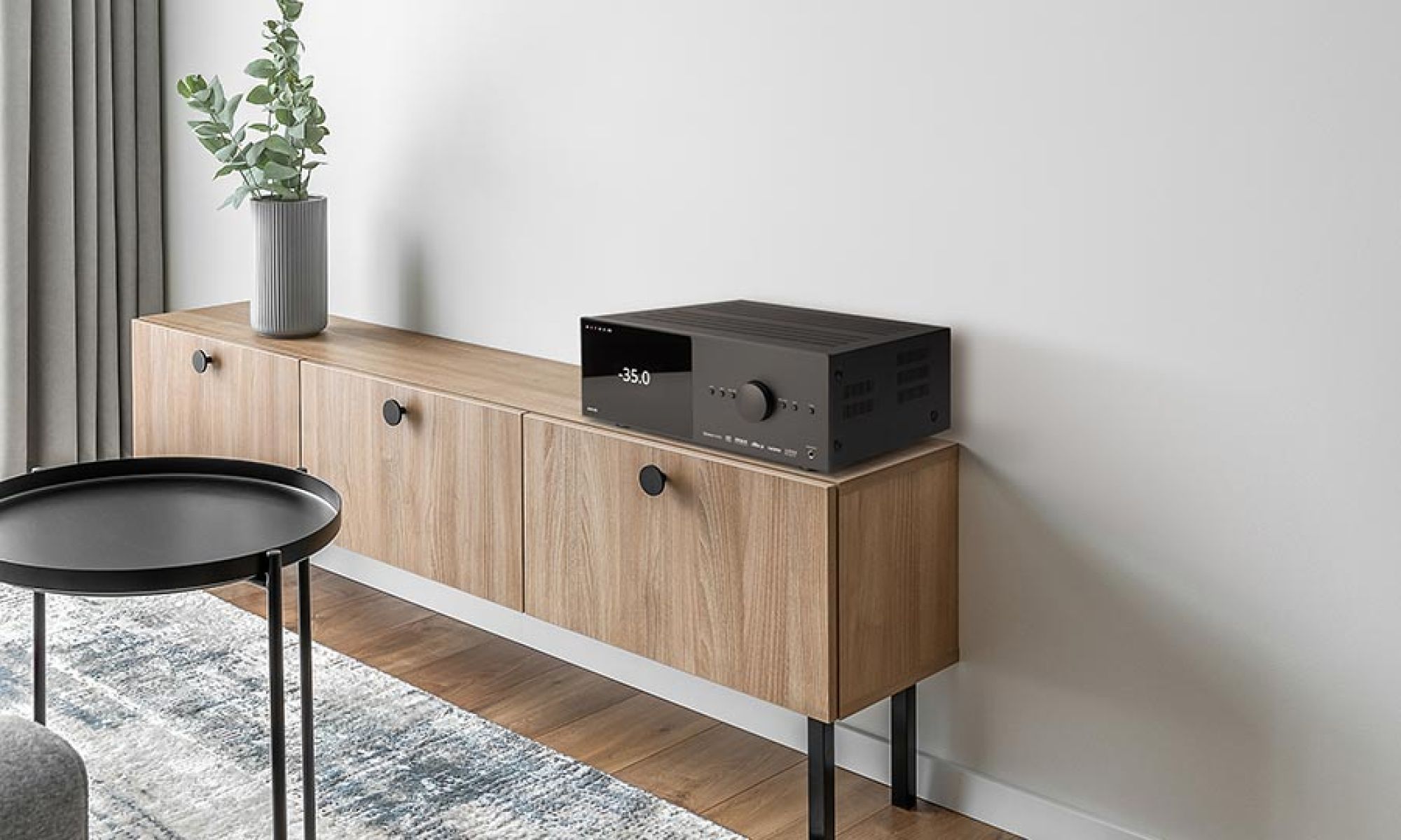 Black audio receiver on a wooden cabinet
