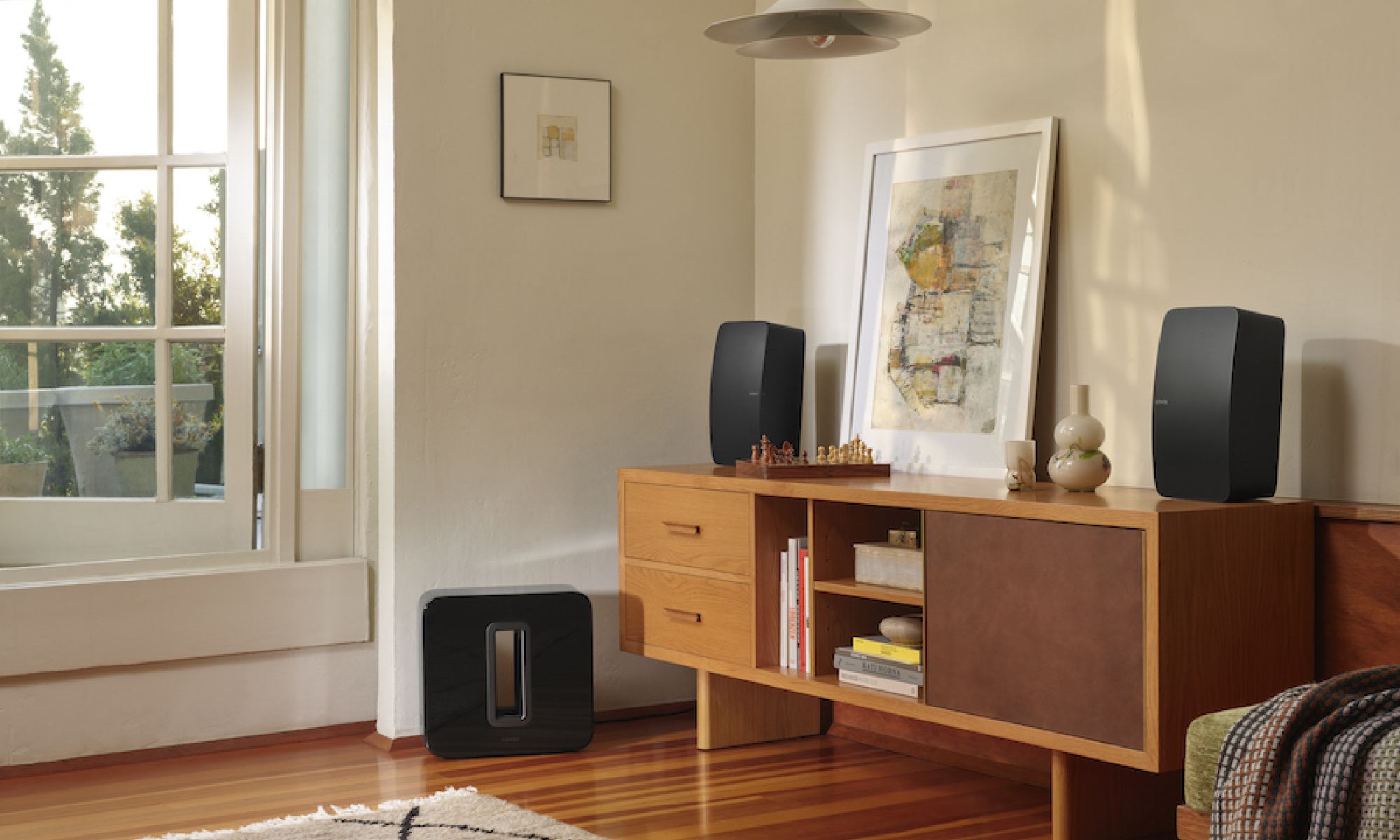 Modern living room with a speaker on a stand next to a window