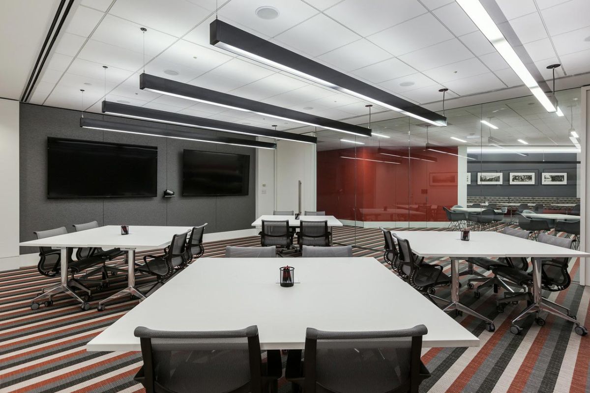 Collaborative meeting room with red accent glass wall