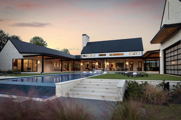 Backyard of a luxury estate. The pool and hardscape area features lighting and AV for premium entertainment.