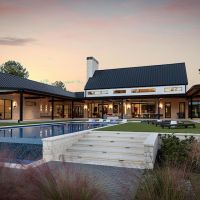 Backyard of a luxury estate. The pool and hardscape area features lighting and AV for premium entertainment.